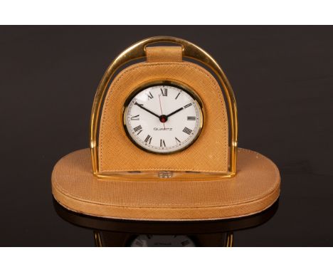 A Gucci travelling clock, the frame in the form of a stirrup, 14cm high CONDITION REPORT: The watch is currently running. Scu