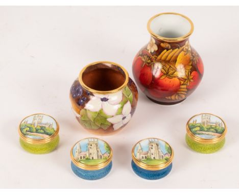 Two Moorcroft enamel vases, Dogwood and Strawberries and four enamel pill boxes CONDITION REPORT: All in very good condition