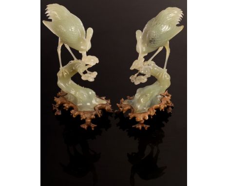 A pair of Chinese carved jade cranes, 28cm high including stands and another carving of a bird on a branch/see illustration C