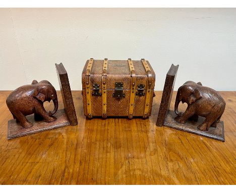 A miniature trunk, the cover with label Boissier, 19cm wide and a pair of carved elephant bookends CONDITION REPORT: Conditio