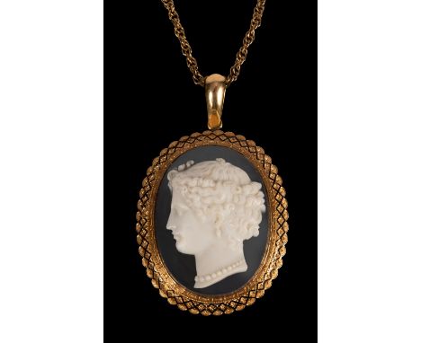 A 19th Century hardstone cameo pendant depicting a female head in profile, the oval gold frame highlighted in enamel, on a fa