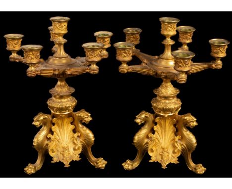 A pair of gilt metal table candelabra, late 19th Century, each with five branches and six lights, on a triform support of leo