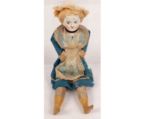 A bisque head doll with wooden legs and arms, 20cm long, five small French dolls, various and a bisque head doll in Highland 