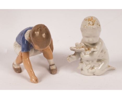 A Bing &amp; Grondahl blanc de chine figurine of a child with seaweed, printed 2266 to base, 10cm high and a Bing &amp; Grond