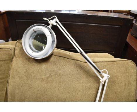 A vintage anglepoise magnifying lamp, designed to be desk mounted