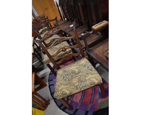 A set of six late 19th or early 20th Century mahogany dining chairs having scroll ladder backs, Chippendale Revival