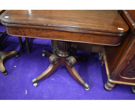 An early 19th Century mahogany framed card or games table with fold out swivel top