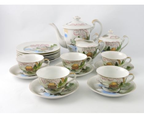 A mid 20th century Japanese eggshell ware tea service, decorated with landscape scenes, the cups incorporating litohphanes, (