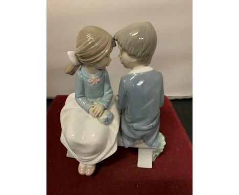 A NAO FIGURINE OF A BOY AND GIRL ON A BENCH 