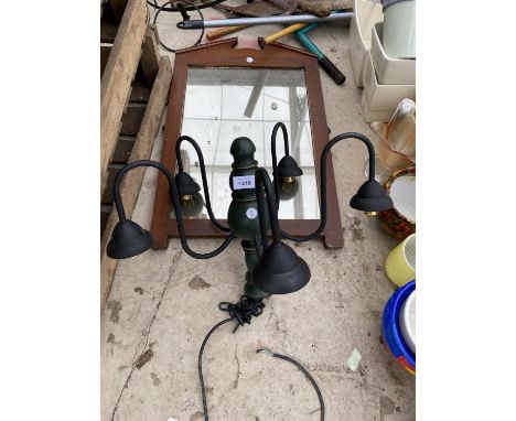 A DECORATIVE WOODEN FRAMED MIRROR AND A LIGHT FITTING 