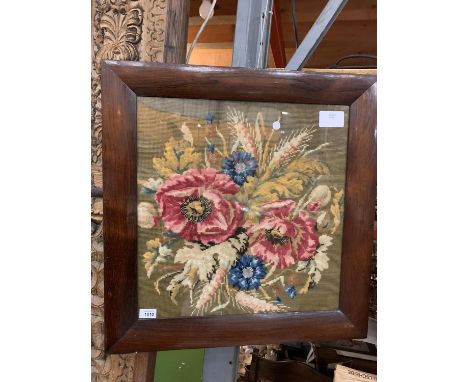 A LARGE TAPESTRY DEPICTING AUTUMN IN THE FORM OF POPPIES, CORNFLOWERS AND EARS OF CORN WITHIN A WIDE WOODEN SQUARE FRAME 