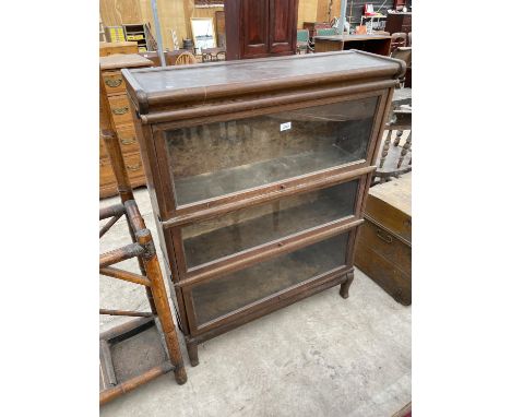 A GLOBE WERNICKE STYLE THREE TIER BOOKCASE, N.B. BACK OF TOP SECTION WORMY 