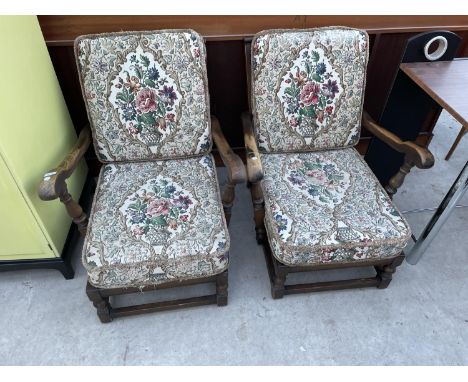 A PAIR OF ERCOL FIRESIDE CHAIRS WITH FITTED CUSHIIONS AND ARCHED BACK DECORATION 