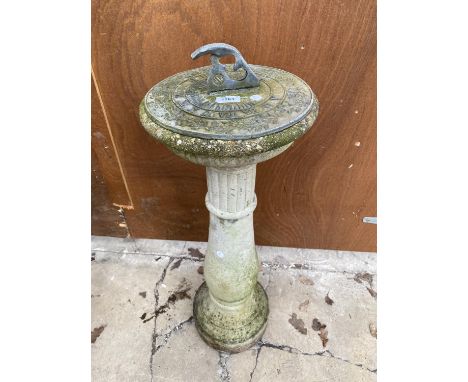 A GARDEN SUNDIAL ON A CONCERETE PEDESTAL BASE 