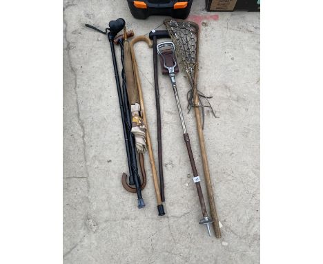 AN ASSORTMENT OF WALKING STICKS TO ALSO INCLUDE A LACROSS STICK AND STICK SEAT ETC 