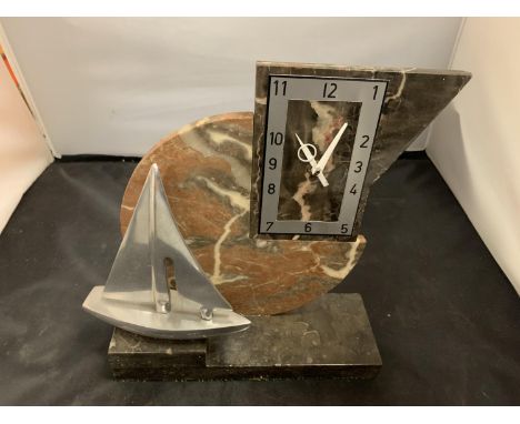 A BATTERY OPERATED MARBLE MANTLE CLOCK IN AN ART DECO STYLE WITH CHROME YACHT DETAIL 