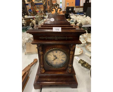 A ORNATE REPRODUCTION WOODEN MANTLE CLOCK WITH FOUR FINIALS (BATTERY OPERATED) 52CMS 