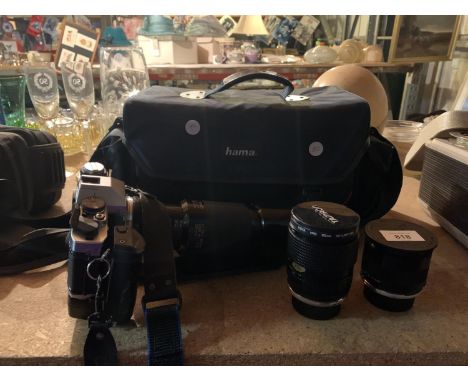 AN OLYMPUS OM 20 SELF TIMER CAMERA AND THREE TAMRON LENSES IN A CARRY CASE 