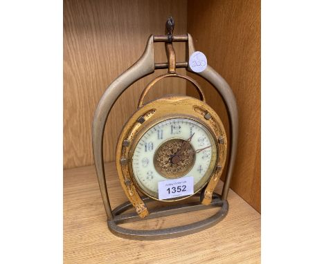A VINTAGE DECORATIVE CLOCK WITH HORSE SHOE DECORATION 