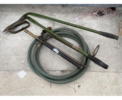 A MANUAL WATER PUMP AND A PAIR OF GRASS SHEARS 