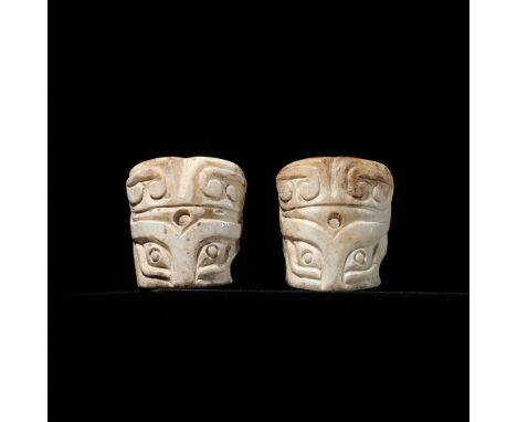 A PAIR OF CYLINDRICAL ‘TAOTIE MASK’ JADE BEADS, SHANG DYNASTY 商代一對饕餮紋玉珠Please note this Lot is to be sold at No Reserve. 本拍品不