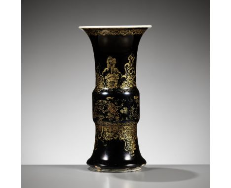 A MIRROR BLACK-GLAZED AND GILT-DECORATED ‘DRAGON’ VASE, GU, KANGXI PERIODPlease note this Lot is to be sold at No Reserve. 本拍