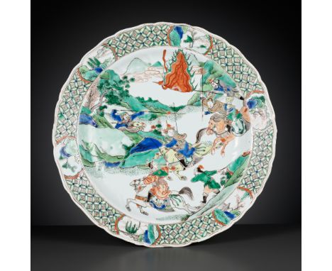 A LARGE AND BARBED FAMILLE VERTE ‘WARRIOR’ DISH, KANGXI PERIOD 康熙大型花口硬彩刀馬人物盤Please note this Lot is to be sold at No Reserve.