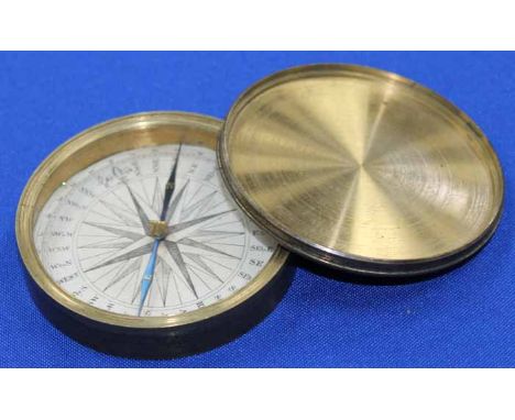 19TH CENTURY BRASS COMPASS
with print paper dial, needle with gilt north and south, 7.5cm in diameter