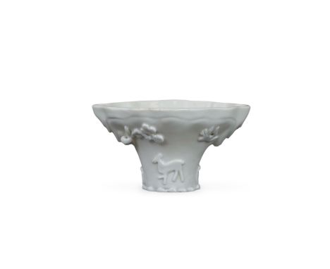 A 'blanc de chine' Libation Cup, Kangxi with moulded and applied flowers and deer, beneath the ivory white glaze Relatively g
