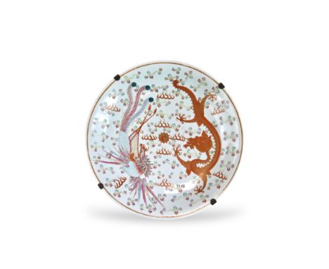 A Dragon and Phoenix Dish, Guangxu,  well decorated with a 'famille rose' phoenix confronting a plunging dragon in iron red a