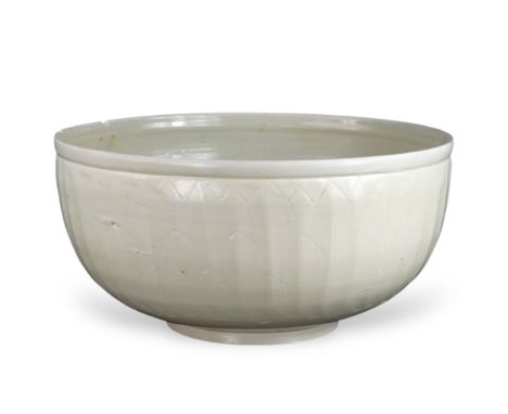 An Extremely Rare Large Carved Ding Fish Bowl, Jin dynasty well potted, with deep gently rounded sides rising from a straight