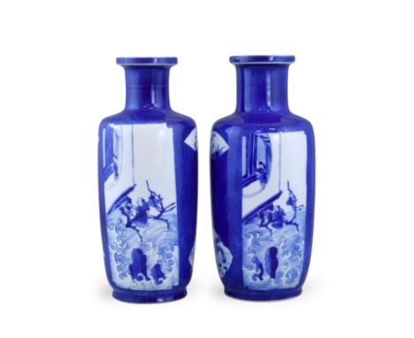 An Attractive Pair of Blue ground Rouleau Vases, Kangxi each decorated against a 'bleu souffle' ground with two tall rectangu