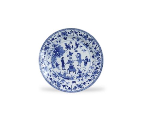 A Rare Blue and White European Subject Dish, Kangxi, decorated in good blue with a central medallion garden scene of two Dutc