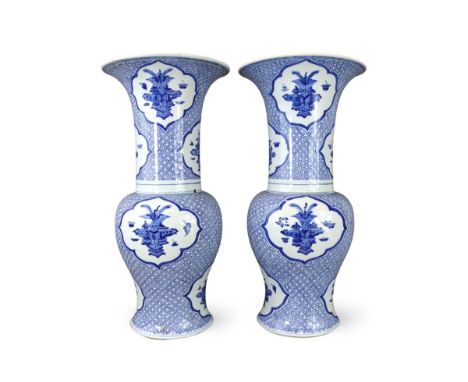 An Attractive Pair of Blue and White 'Phoenix Tail' Vases, Kangxi,  each decorated in rich blue with barbed vignettes of the 