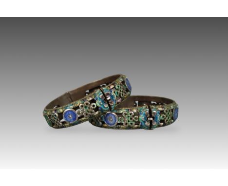 A Pair of Silver and Enamel Bangles, late Qing dynasty, the exterior with openwork decoration of alternating  'cash' and 'End