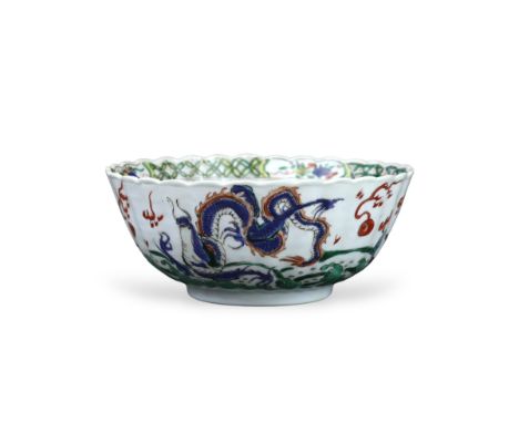 A 'famille verte' Dragon Bowl, Kangxi,  the fluted sides strikingly enamelled with three fierce dragons chasing the 'flaming 