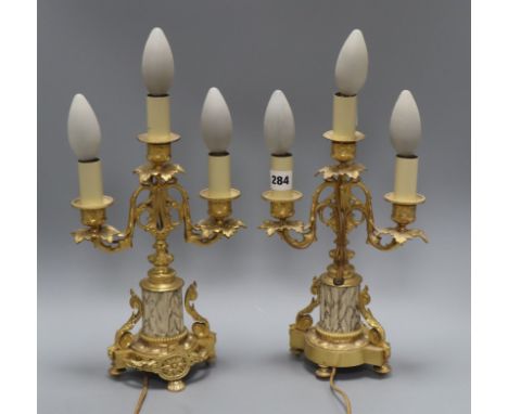 A pair of ormolu three light candelabra