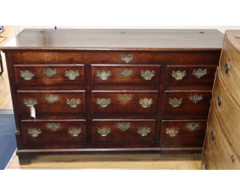 An 18th century oak and mahogany cross-banded chest, having hinged lid and six dummy drawers above three base drawers fitted 