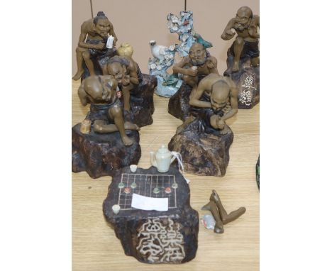 A set of five earthenware figures playing "Go" and one other item tallest 23cm