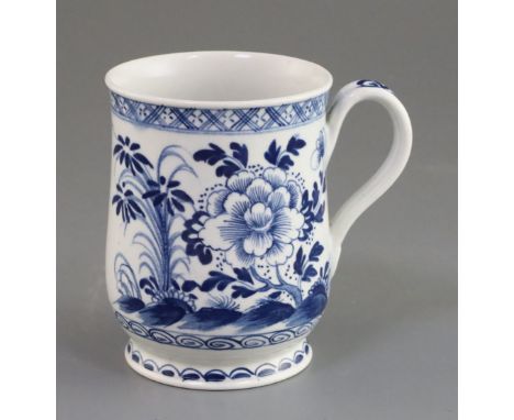 A Bow bell-shaped blue and white mug, c.1770 painted with flowers rockwork and insects, unmarked, H. 11.3cmex Barbara Leake c