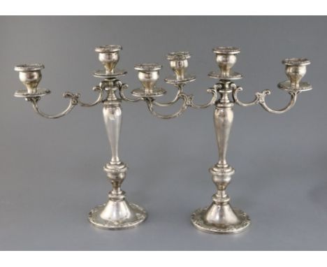 A pair of American Gorham sterling silver, two branch, three light candelabra, decorated with scroll borders, height 35.5cm, 