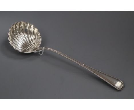 A Victorian silver beaded Old English pattern soup ladle by George Adams, London, 1869, 34cm, 8 oz.