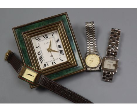 A Gucci travelling desk clock and three Gucci wrist watch including 925.
