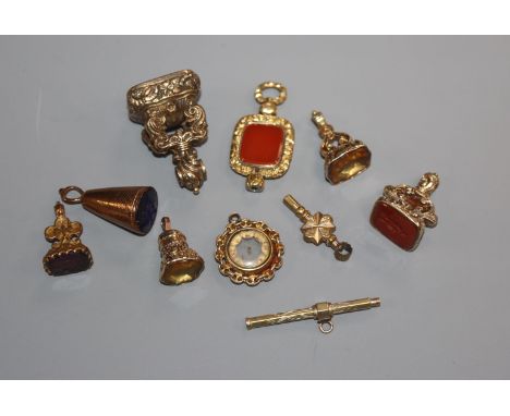 Seven assorted 19th century and later yellow metal overlaid fob seals, propelling pencil, watch key and compass.