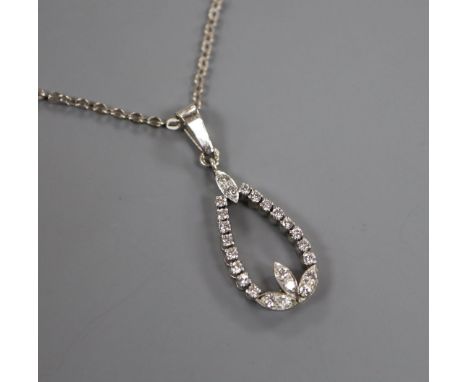 A white metal and diamond pear shaped openwork pendant, on a 14k white metal chain, pendant 20mm.