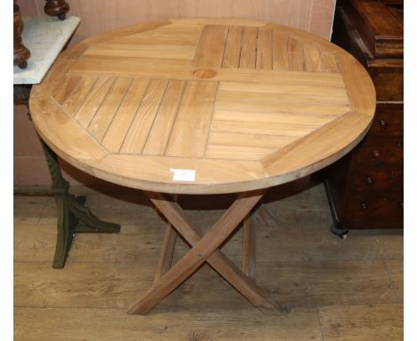 A circular teak folding garden table Diam.90cm