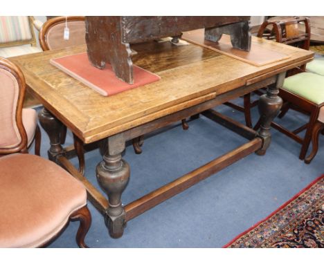 An oak drawleaf refectory table 256cm extended