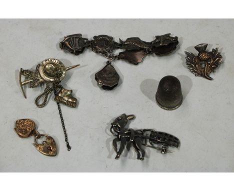 A silver nautical bracelet; a Scottish silver thistle brooch; a silver thimble 