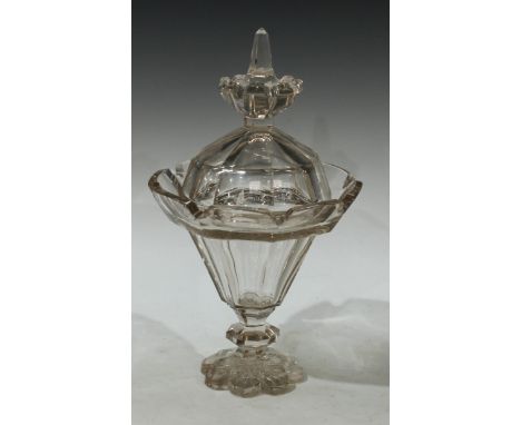 A 19th century glass lantern-shaped pedestal sweetmeat vase and cover, slightly tapering, panelled throughout, outswept crene