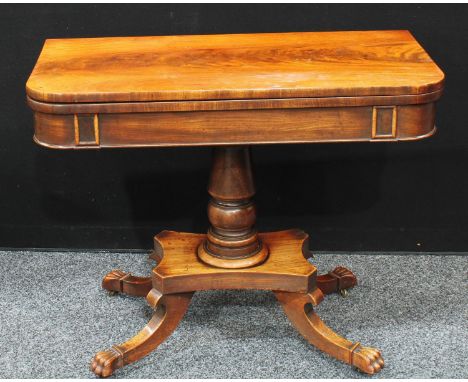 A Regency mahogany card table, folding rectangular top enclosing a baize lined playing surface, turned column, incurve rectan